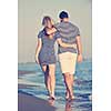 happy young couple have romantic time on beach at sunset