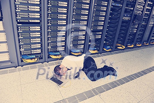 young it engeneer business man with thin modern aluminium laptop in network server room young it engeneer business man with thin modern aluminium laptop in network server room