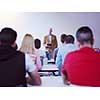 group of students study with senior professor in modern school classroom on creative class