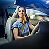 Pretty, young woman  driving a car -Invitation to travel. Car rental,  car ownership or vacation