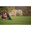 Young woman with her black dog  outdoor, in a park playing frisbee - shallow DOF, sharp focus