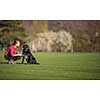 Young woman with her black dog  outdoor, in a park playing frisbee - shallow DOF, sharp focus