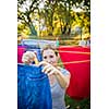 Young woman putting laundry on a rope in her garden,  taking great care of her family on a daily basis