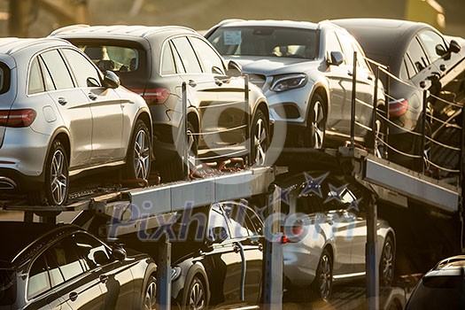 Brand new cars being transported on a truck on a highway Brand new cars being transported on a truck on a highway
