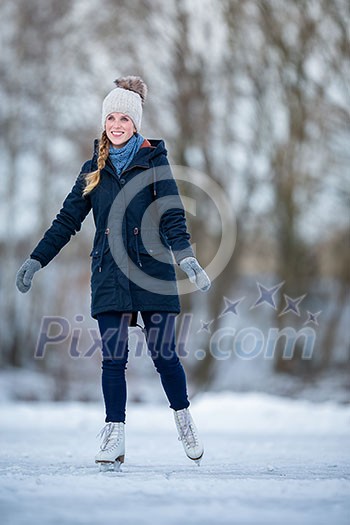 Young woman ice skating outdoors on a pond on a freezing winter day Young woman ice skating outdoors on a pond on a freezing winter day