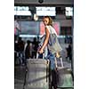 Young woman with her luggage at an international airport, before going through the check-in and the security check before her flight