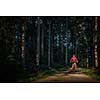 Pretty, young woman biking on a mountain bike enjoying healthy active lifestyle outdoors in summer (shallow DOF)