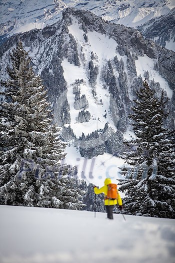 Ski-alpinist walking through lovely alpine landscape