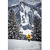 Ski-alpinist walking through lovely alpine landscape