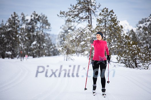 Cross-country skiing: young woman cross-country skiing on a winter day