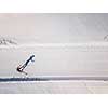 Cross-country skiing: young woman cross-country skiing on a winter day (motion blurred image) - aerial image