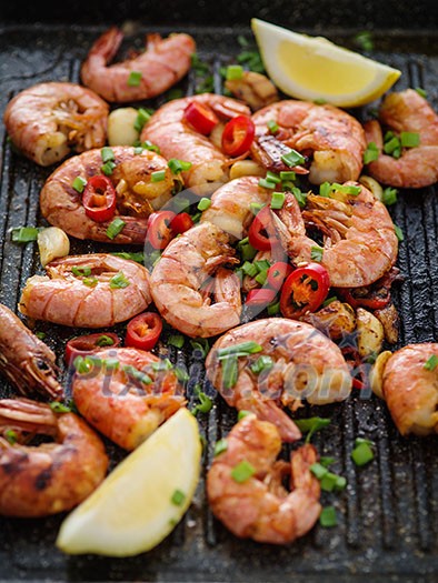 Large grilled BBQ shrimp with sweet chili sauce, green onion and lemon Large grilled BBQ shrimp with sweet chili sauce, green onion and lemon