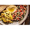 Shwarma in a plate with hummus and salad