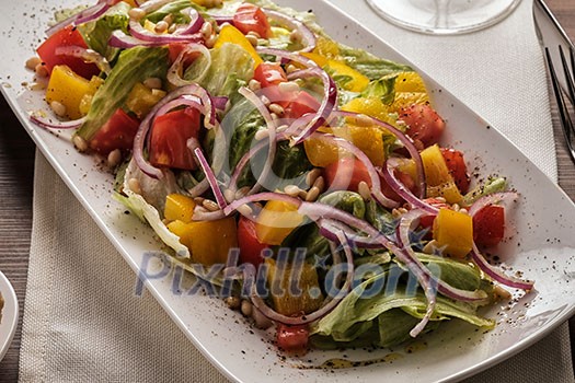 Salad with tomato pepper and onion. Healthy eating. Vegetable seasonal salad in white.