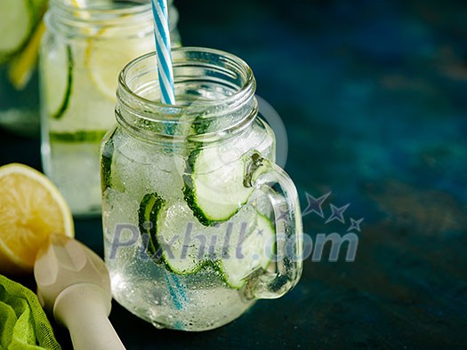 Fresh Summer Drink. Healthy detox fizzy water with lemon and cucumber in mason jar. Healthy food concept. Detox diet. Fresh Summer Drink. Healthy detox fizzy water with lemon and cucumber in mason jar. Healthy food concept. Detox diet.
