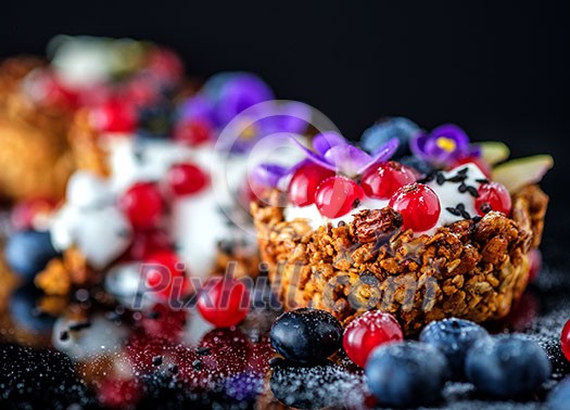 Dessert with sunflower seeds, yogurt and fresh berries on black