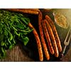 Grilled sausages and stewed cabbage on a wooden table. Rustic style. Snacks for the Oktoberfest. Top view.