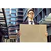 Businessman in a city street holding a blank banner