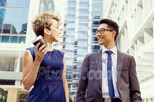 Business people having a talk while walking in a businesss district
