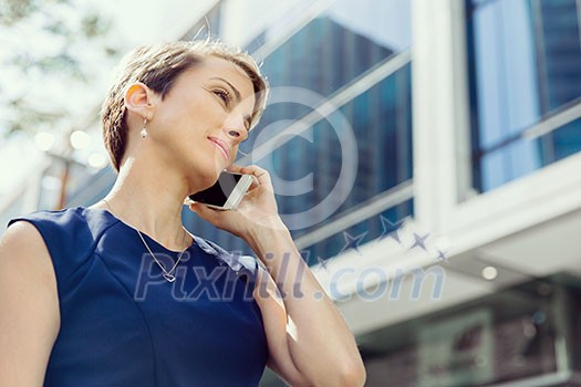 Businesswoman with a phone in a city