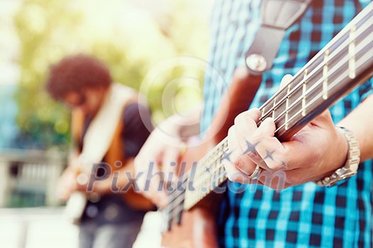 A street musician playing his guitar A street musician playing his guitar
