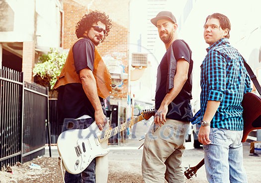 Band of musicians walking away in the street