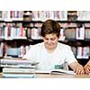 Boy in library with books