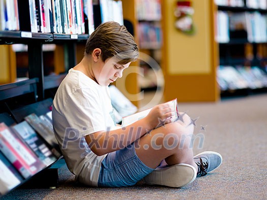 Boy in library with books