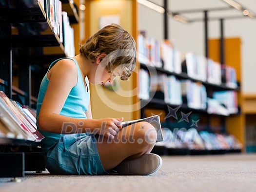 Boy in library with books