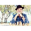 Elderly man sitting outdoors with chess