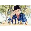 Elderly man sitting outdoors with chess