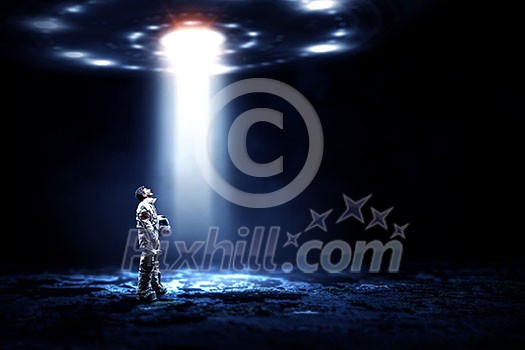 Astronaut man wearing suit in space. Mixed media Astronaut man wearing suit in space. Mixed media