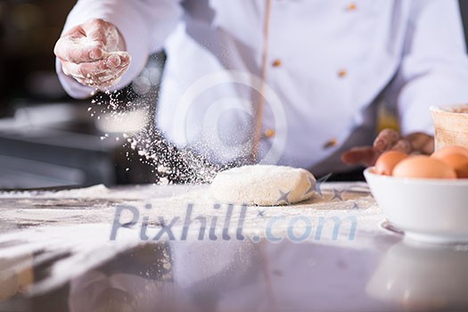 chef hands preparing dough for pizza on table sprinkled with flour closeup chef hands preparing dough for pizza on table sprinkled with flour closeup