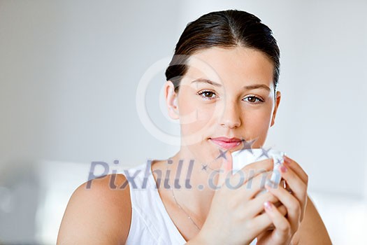 Attractive young woman with cup of tea or coffee at home Attractive young woman with cup of tea or coffee at home