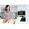 Image of beautiful woman standing in the kitchen and cooking