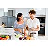 Couple cooking together in the modern kitchen at home