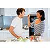 Couple cooking together in the modern kitchen at home