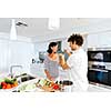 Couple cooking together in the modern kitchen at home