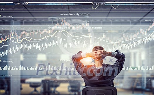 Relaxed businessman at the office sitting back with his hands behind his head