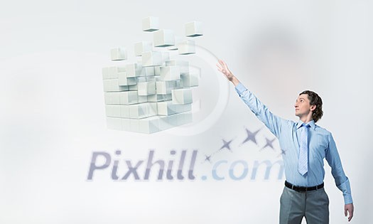 Businessman reaching hand to touch 3D rendering cube figure Businessman reaching hand to touch 3D rendering cube figure