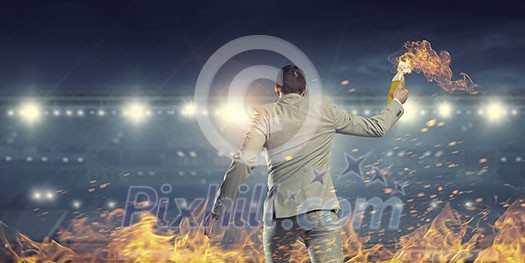 Aggressive businessman in suit throwing burning molotov cocktail