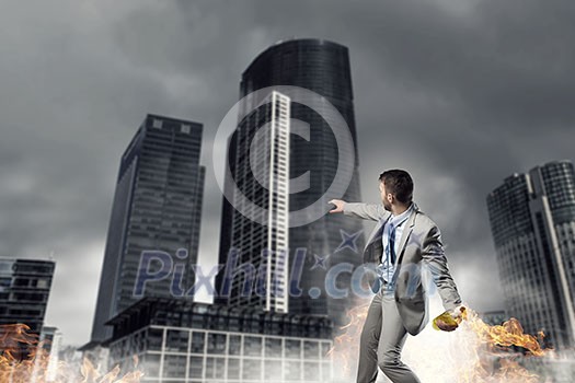 Aggressive businessman in suit throwing burning molotov cocktail Aggressive businessman in suit throwing burning molotov cocktail