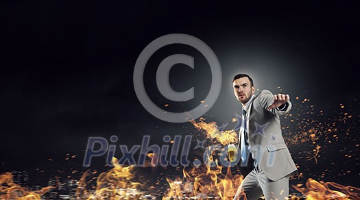 Aggressive businessman in suit throwing burning molotov cocktail