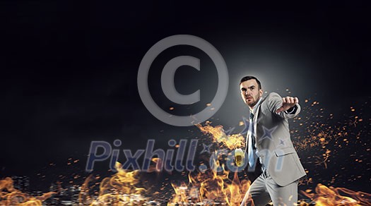 Aggressive businessman in suit throwing burning molotov cocktail Aggressive businessman in suit throwing burning molotov cocktail
