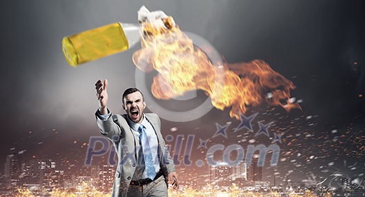 Aggressive businessman in suit throwing burning molotov cocktail Aggressive businessman in suit throwing burning molotov cocktail
