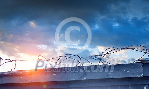 Concept of security with concrete fence and wire. Mixed media Concept of security with concrete fence and wire. Mixed media