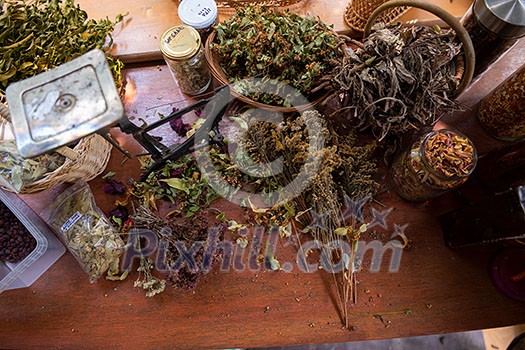 herbalist workshop with bottles and healing herbs top view