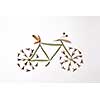 Bicycle made from leaves and pine seeds presented on a gray background with space for text. The concept of sports and healthy lifestyle. Flat lay
