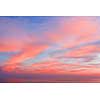 Blue sky at sunset with clouds of color living coral around the sea. Natural beautiful background