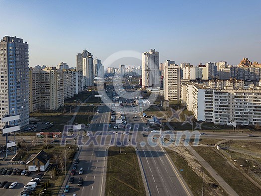 A bird's eye view from drone to the Darnyts'kyi district, Poznyaki of Kiev, Ukraine with modern buildings on a background of blue sky in the spring.